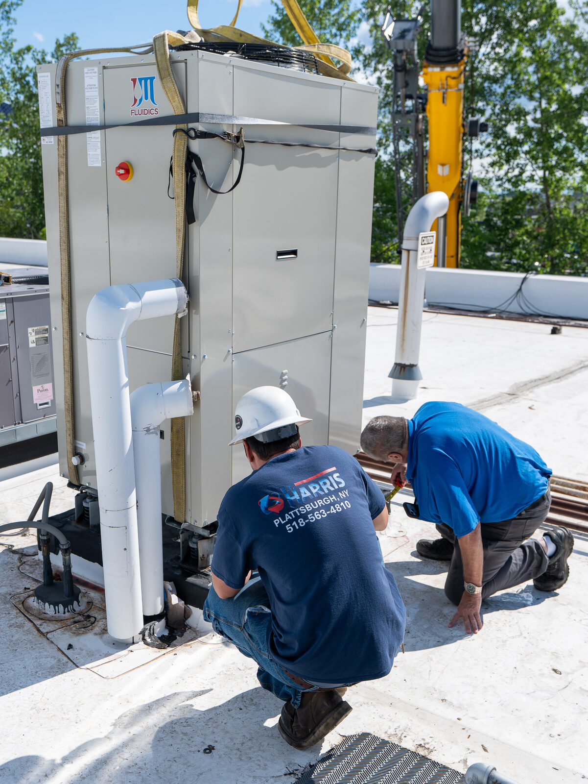 HVAC technicians installing commercial equipment